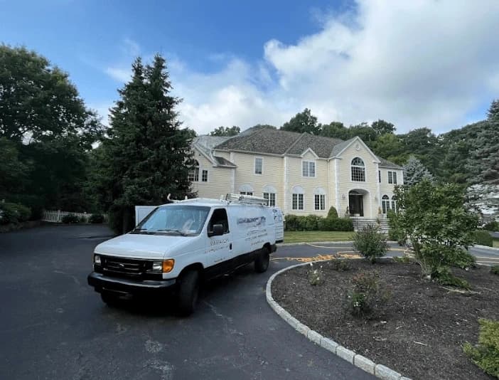 Elyria Power Washing technician performing thorough gutter cleaning service in Elyria